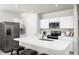 Modern kitchen with white cabinets, stainless steel appliances, and a center island at 4214 Cattail Marsh Dr, Lakeland, FL 33811