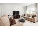 Cozy living room with comfortable sofas, a TV, and a large window for natural light at 4214 Cattail Marsh Dr, Lakeland, FL 33811