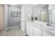 Modern bathroom featuring a white vanity with a large mirror and decorative orchids at 4220 Cattail Marsh Dr, Lakeland, FL 33811