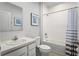 Bright bathroom with a tub/shower combo, a white vanity, and blue and white accents at 4220 Cattail Marsh Dr, Lakeland, FL 33811
