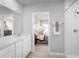 Bathroom with white cabinets, a shower and view of a bedroom with a plush bed at 4220 Cattail Marsh Dr, Lakeland, FL 33811