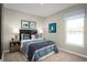 Comfortable bedroom featuring a large bed with blue bedding, decorative pillows, and a matching window valance at 4220 Cattail Marsh Dr, Lakeland, FL 33811