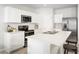 Bright and airy kitchen featuring modern appliances, white cabinets, and a convenient breakfast bar, perfect for casual dining at 4220 Cattail Marsh Dr, Lakeland, FL 33811