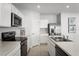 Contemporary kitchen with stainless steel appliances, sleek white cabinetry, and ample counter space, ideal for cooking and entertaining at 4220 Cattail Marsh Dr, Lakeland, FL 33811