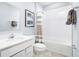This is a bathroom with a large white vanity, white tub, with striped curtain, and light blue walls at 4226 Cattail Marsh Dr, Lakeland, FL 33811