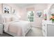 Bright bedroom with pink walls, light carpet, and cute animal artwork over the bed at 4226 Cattail Marsh Dr, Lakeland, FL 33811