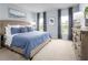 Serene main bedroom featuring a blue color scheme, plush carpet, and natural light at 4226 Cattail Marsh Dr, Lakeland, FL 33811