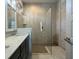 Elegant bathroom featuring dual sinks, a glass-enclosed shower with stylish tile work, and modern fixtures at 1567 Lake Reserve Dr, Deland, FL 32724