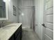 Cozy bathroom featuring a modern sink, bathtub with shower, and a neutral-toned shower curtain at 1567 Lake Reserve Dr, Deland, FL 32724