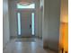 Bright foyer features neutral tile flooring and a stylish light fixture at 1567 Lake Reserve Dr, Deland, FL 32724