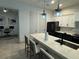 Modern kitchen featuring white cabinets, dark hardware, and a quartz countertop island at 1567 Lake Reserve Dr, Deland, FL 32724