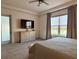 Spacious main bedroom features a large window offering a serene view, complemented by a modern ceiling fan at 1567 Lake Reserve Dr, Deland, FL 32724