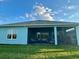 View of the screened patio area with comfortable seating, perfect for outdoor relaxation and entertaining at 1567 Lake Reserve Dr, Deland, FL 32724