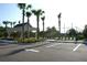 View of tennis courts, surrounded by palm trees and manicured landscaping, with a covered picnic table area at 1567 Lake Reserve Dr, Deland, FL 32724