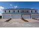 Row of townhome garages showcasing brick paved driveway and well maintained landscape at 674 Four Leaf Ave, Debary, FL 32713