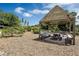 Wooden gazebo provides shade for benches and a table in a community garden setting at 6917 Five Oaks Dr, St Cloud, FL 34773