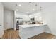 Bright kitchen featuring modern, stainless steel appliances, white cabinets, and a large quartz countertop at 6917 Five Oaks Dr, St Cloud, FL 34773