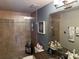 Bathroom featuring neutral wall tones, modern lighting, tiled shower with glass doors and granite counters at 1425 Ocean Shore Blvd # 402, Ormond Beach, FL 32176