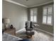 Sitting area in main bedroom features two large windows with wood flooring at 1425 Ocean Shore Blvd # 402, Ormond Beach, FL 32176