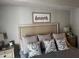 Comfortable bedroom featuring a queen bed with decorative pillows, and nightstands with lamps at 1425 Ocean Shore Blvd # 402, Ormond Beach, FL 32176