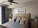 Comfortable bedroom featuring a queen bed with decorative pillows, and nightstands with lamps at 1425 Ocean Shore Blvd # 402, Ormond Beach, FL 32176