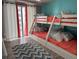 Comfortable bedroom featuring bunkbeds with decorative pillows, an area rug and natural lighting at 1425 Ocean Shore Blvd # 402, Ormond Beach, FL 32176
