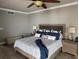 Comfortable bedroom featuring a ceiling fan, wood flooring, and a king-sized bed at 1425 Ocean Shore Blvd # 402, Ormond Beach, FL 32176