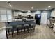 Stylish kitchen with white cabinetry, a black refrigerator, and a breakfast bar with seating for four at 1425 Ocean Shore Blvd # 402, Ormond Beach, FL 32176
