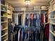 Organized walk-in closet with shelves and rods for ample storage and functional design at 1425 Ocean Shore Blvd # 402, Ormond Beach, FL 32176