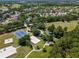 Community park aerial featuring a playground, basketball court, and volleyball court surrounded by trees at 3317 Grande Heron Dr, St Cloud, FL 34773