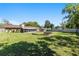 Large backyard featuring a fire pit area and screened porch, offering ample space for outdoor activities and relaxation at 3200 Se 34Th St, Ocala, FL 34471