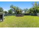 Spacious backyard featuring a built-in fire pit area, perfect for entertaining and enjoying the outdoors at 3200 Se 34Th St, Ocala, FL 34471