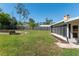 Spacious backyard featuring a lush lawn, privacy fence, and raised garden beds, perfect for outdoor activities at 3200 Se 34Th St, Ocala, FL 34471
