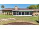 Backyard featuring a screened-in porch, lovely greenery, and an inviting fire pit area, perfect for outdoor living at 3200 Se 34Th St, Ocala, FL 34471