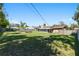 Wide view of the large backyard with wooden fire pit area, screened in porch and plenty of space to enjoy the outdoors at 3200 Se 34Th St, Ocala, FL 34471
