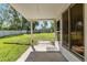 Covered patio offering a view of a well-maintained backyard with lush grass and a privacy fence at 3200 Se 34Th St, Ocala, FL 34471