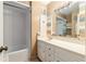 Bathroom vanity with decorative elements, mirror, tub, and ample lighting at 3200 Se 34Th St, Ocala, FL 34471