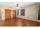 Bedroom with wood floors, ceiling fan, closet space, and window at 3200 Se 34Th St, Ocala, FL 34471