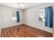 Bedroom featuring an updated ceiling fan, hard surface floors, and natural light from two windows at 3200 Se 34Th St, Ocala, FL 34471