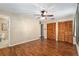 Bedroom with wood floors, ceiling fan, closet space, and access to bathroom at 3200 Se 34Th St, Ocala, FL 34471