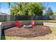 Backyard fire pit area complete with seating and a well-maintained lawn, creating a cozy outdoor space at 3200 Se 34Th St, Ocala, FL 34471