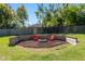 Backyard fire pit area with seating, ideal for enjoying evenings outside at 3200 Se 34Th St, Ocala, FL 34471