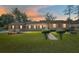 Charming single-story home with well-manicured lawn and neatly trimmed shrubs under a vibrant sunset sky at 3200 Se 34Th St, Ocala, FL 34471