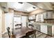 Kitchen and dining area featuring gray cabinetry, white appliances, and modern flooring at 3200 Se 34Th St, Ocala, FL 34471