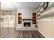 Cozy living room featuring a brick fireplace, mantel with built-in shelving, and modern flooring at 3200 Se 34Th St, Ocala, FL 34471