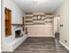 Living room featuring a painted brick fireplace and decorative wood accent wall at 3200 Se 34Th St, Ocala, FL 34471