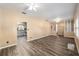Spacious living room with updated flooring, ceiling fan, and view into kitchen area at 3200 Se 34Th St, Ocala, FL 34471