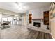 Open-concept room with fireplace, ceiling fan and grey cabinets offering plenty of space for dining and entertaining at 3200 Se 34Th St, Ocala, FL 34471
