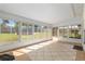 Sunroom featuring tiled floors, large windows offering backyard views, and ample natural light for year-round enjoyment at 3200 Se 34Th St, Ocala, FL 34471