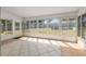 Bright sunroom with tile floors and multiple sliding glass windows offering panoramic views of the backyard at 3200 Se 34Th St, Ocala, FL 34471